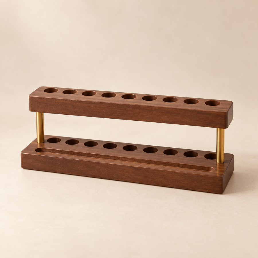 Brown nine-slot pen holder with brass-coloured supports on cream