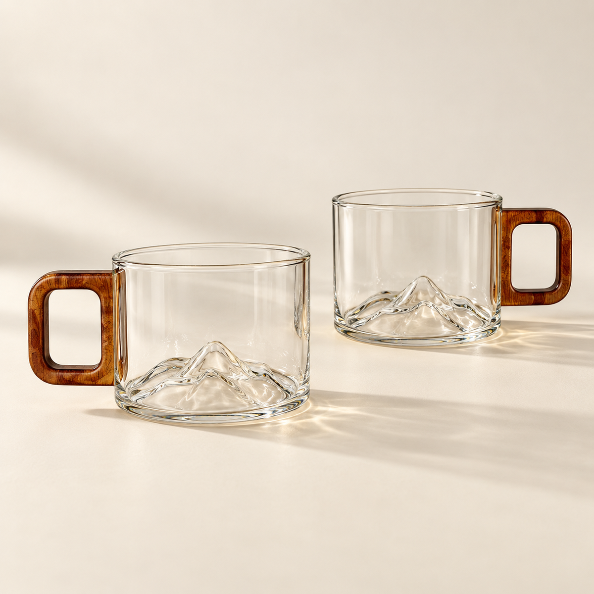 2 matching clear Ridgeline glass coffee cups on a cream background