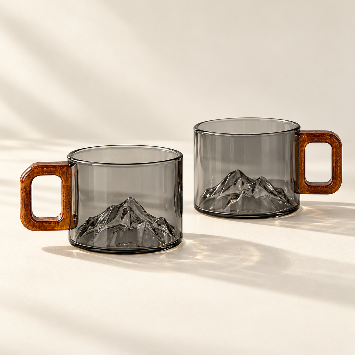 2 matching smoke-grey Ridgeline glass coffee cups on a cream background